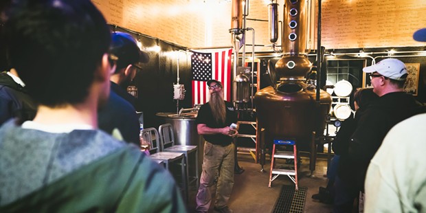 Steve Bohner gives visitors a tour of the distillery.