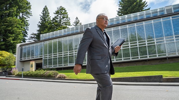 New Humboldt State University President Tom Jackson Jr. strolls across campus on June 28, his first day on the job.