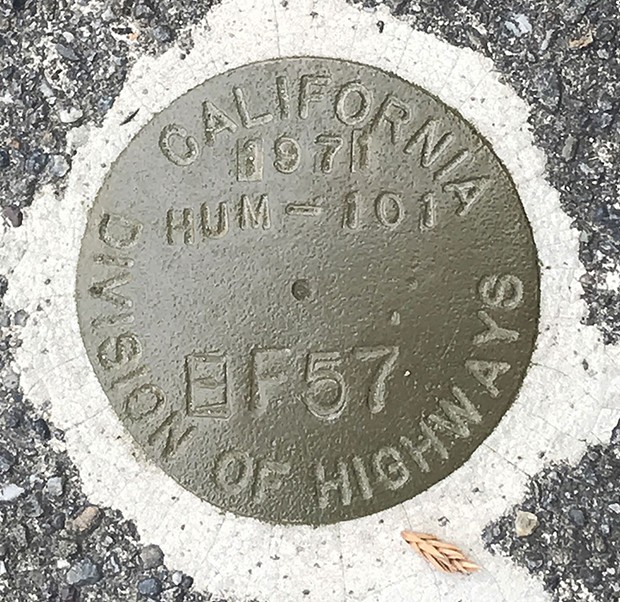 Cold forged silicon bronze survey marker at Ninth and I streets in Eureka. This would have been the centerline of U.S. Highway 101, had the Caltrans proposed relocation of 50 years ago gone ahead.