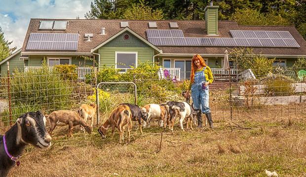 Karin Eide at the farm, in front of the solar-powered cheese-making facility.