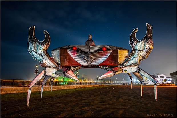 A 14-foot tall, 24-foot wide metal crab kinetic sculpture by Daniel McCauley and Al Hoffman rests down at the Eureka Waterfront. McCauley is in the turret, wearing a welded metal mask he also made. The light-colored tubing outlining the pincers is neon flexible tubing that is brilliant when lit, but it was not powered for this shot. Dec. 2, 2020, Humboldt County, California.