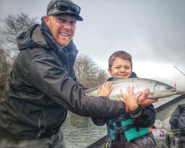Eight-year-old Bryson Blevin, along with dad Tyler, are all smiles after the young angler landed his first-ever steelhead while fishing the Mad River on Saturday.