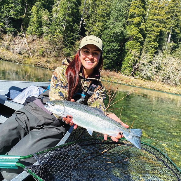 Haley Richards, of Salem, Oregon, holds a steelhead she caught and released March 13 while fishing the Smith River with guide Rye Phillips      of Wild Rivers Fishing.