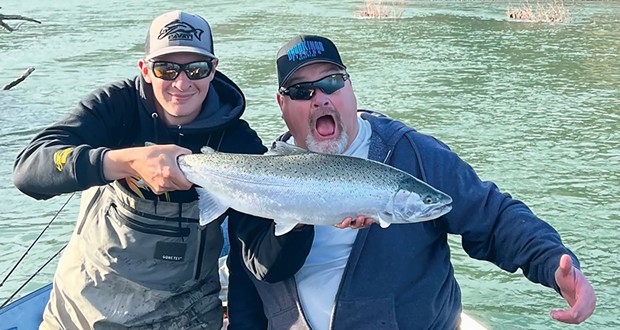Guide Michael McGahan of Brookings Fishing Charters holds a steelhead caught Dec. 17 on the Chetco River by Larry Clark of Brookings.