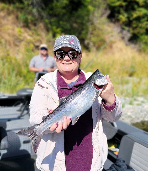 Eureka resident Tia Hauan holds a jack salmon taken on the lower Klamath earlier in the season.