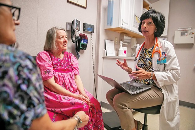 Nurse practitioner Surani Hayre-Kwan, right, speaks with patient Mary Valesano, left, and her caregiver Georgia Manolakos-Fraley, during a check-up at the Russian River Health Center in 2020.