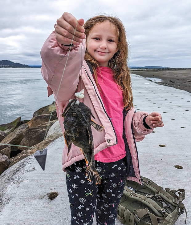 Eight-year-old Isabell Kelly, of Arcata, holds a rockfish she caught last Saturday from the north jetty.