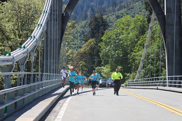 Youth from Orleans join in the run and carry the salmon batons across the Klamath River on May 19.