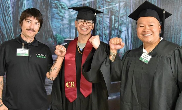 Tony Wallin-Sato, College of the Redwoods Pelican Bar Scholars graduate Bunthoeun Roeung, and special guest graduation speaker David Nguyen pose during the 2023 spring graduation in Pelican Bay State Prison.