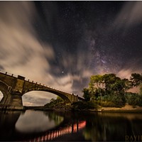Historic Fernbridge sits out in the cosmos beneath a layer of sweeping clouds and the majestic Milky Way. Mars is bright at center. The lights from passing cars illuminated the shore and provided the reflections. Sept. 11, 2018.