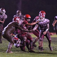 McKinleyville Panther running back Caleb Martinez is swarmed by Hoopa Warrior defenders. It was a wet and muddy affair as the Warriors took advantage of a slick field to pound out a win over the homecoming-celebrating McKinleyville Panthers 22-12 Saturday night.