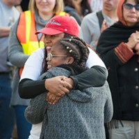 Charmaine Lawson hugs Sadie Shelmire, 11, after Shelmire spoke of the racism she has experienced in Humboldt County.