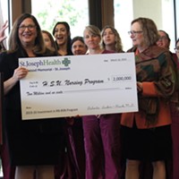 Humboldt State University President Lisa Rossbacher (right) receives a $2 million check from St. Joseph Hospital for the university's new nursing program.