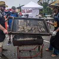 Pitmaster John McClurg (Left) and volunteers Ryan (middle) and Gilbert helped wrangle the grilled salmon.