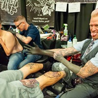 Tattoo artist Jojo Miller pulls on the gloves.