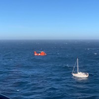 A Coast Guard helicopter comes in for the rescue.