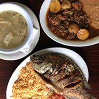 Minimalist white menudo, barbacoa and fried mojarra fish.
