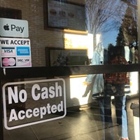 A "No Cash Accepted" sign at a restaurant.