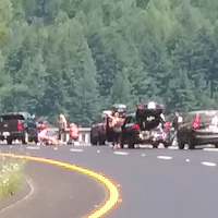 People tend to the injured motorcyclist. [Photo provided by Mark Nelson V]