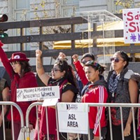 2018 Women's March San Francisco attendees raise fists and hold signs in support of missing and murdered indigenous women.