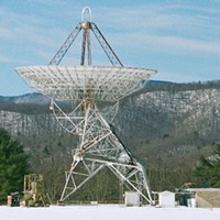 The 85-foot Green Bank WV radio telescope used by Frank Drake in 1960 to monitor two relatively nearby stars for signs of life by "listening" to the wavelength emitted naturally by interstellar hydrogen.