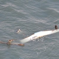 The commercial crab fishing vessel SUNUP is destroyed near the entrance channel in Humboldt Bay, Calif., January 24, 2021. The Coast Guard rescued the three people aboard the SUNUP after the vessel lost propulsion and collided with the jetties while attempting to transit through the entrance channel.