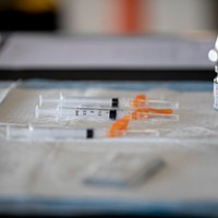 A vial of the Modern COVID-19 vaccine and syringes on a table at a drive through distribution site at Cal Expo in Sacramento on Jan. 21, 2021.