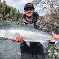 Parker Lowe, of Yuba City, holds a wild steelhead he caught and released Feb. 20 while fishing the Smith River with guide Andy Martin of Wild Rivers Fishing. He was using a pearl-pink Corky and roe.