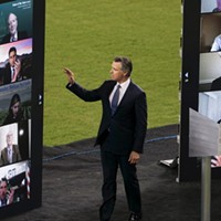 Gov. Newsom waves to virtual guests during the State of the State address at Dodger Stadium on March 9, 2021.