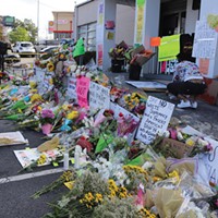 Memorial signs and flowers in front of Gold Spa in Atlanta, one of the locations where Suncha Kim, Hyun Jung Grant and Soon Chung Park were killed.
