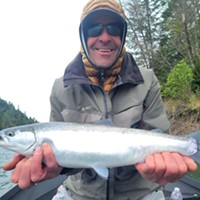 Scott Spangler of Bishop holds a small wild adult steelhead he caught March 21 on the Chetco River while fishing with guide Sam Stover of Brookings Fishing Charters.