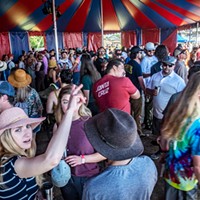 The new off-plaza venue for the Oyster Fest attracted thousands, many of whom ended up in long food and drink lines snaking around the grounds and even into the welcome shade of this large vendor tent.