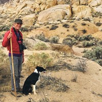 The author hiking with trusty companions, the walking stick and Pip the dog.