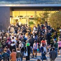 Students and community members gather outside Siemens Hall amid a standoff between police and protesters occupying the building on April 22.