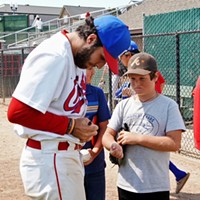 Jeff Ruby signs autographs after the Crabs' win Sunday.