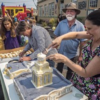 Shoshanna Rose (right), of Arcata, helped cut and serve the Creamery Building replica cake that building owners Lisa and Brian Finigan, of Arcata, brought to share with Fervor Fest attendees.