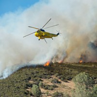A Sikorsky helicopter prepares to refill its water hold to combat the Pawnee Fire earlier this week.