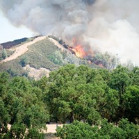 Fire breaks over a ridge at the Pawnee Fire last week.
