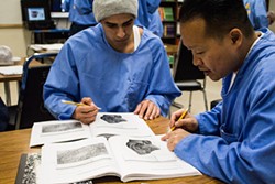 PHOTO BY T.WILLIAM WALLIN - David Nguyen (right) works with a fellow student on a plant experiment in a College of the Redwoods biology lab course at Pelican Bay State Prison.