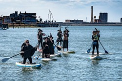 PHOTOS BY MARK LARSON - The witch paddlers headed past the foot of F Street and the end of the Eureka Boardwalk toward the Adorni Center and Woodley Island.