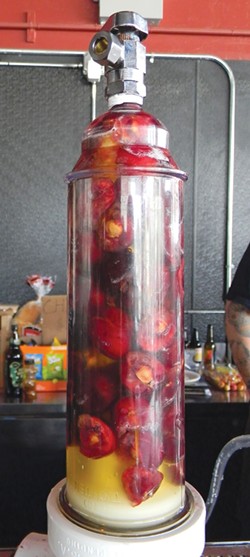 PHOTO BY CARRIE PEYTON DAHLBERG - Wheat beer and cherries blend in an infusing device at Dead Reckoning Tavern in Arcata.