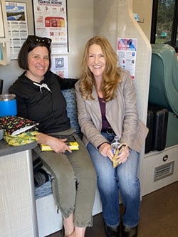 Betsy Musick, owner - of the Trinidad Eatery Restaurant, with Blood Drive Chair Gail Saunders - in the Blood Mobile in March.