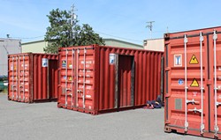 PHOTO BY THADEUS GREENSON - Shipping containers sit ready to be converted into living quarters in the vacant lot owned by Mercer Fraser Co. at the corner of Third and Commercial streets in Eureka.