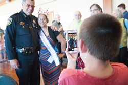 PHOTO BY MARK MCKENNA - Miss Independence Day Queen Meghan McCracken and Mills pose while Quentin Glass, 8, takes a photo on McCracken's phone.