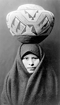 Young Zuni woman with jar.